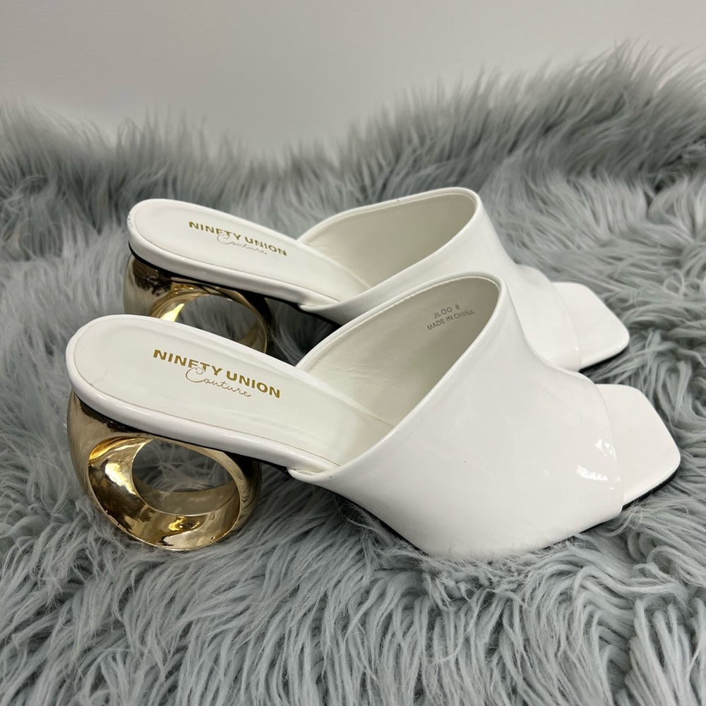 White shoe with a Gold circular heel